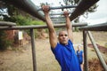 Fit man climbing monkey bars Royalty Free Stock Photo
