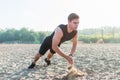 Fit man doing clapping push-ups during training exercise workout on beach in summer. Royalty Free Stock Photo