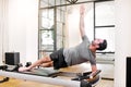 Fit man doing pilates side elbow plank exercises