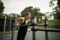 Fit man doing triceps dips on parallel bars at park exercising outdoors Royalty Free Stock Photo