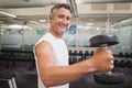 Fit man lifting heavy black dumbbell