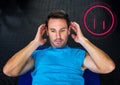 Fit man performing crunches exercise in gym against fitness interface in background