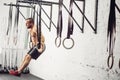 Fit man pulling up on gymnastic rings. Royalty Free Stock Photo