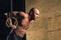 Fit man pulling up on gymnastic rings. Royalty Free Stock Photo