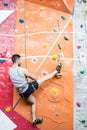 Fit man rock climbing indoors Royalty Free Stock Photo