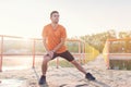 Fit man warming up doing lunges exercising during morning run. Royalty Free Stock Photo