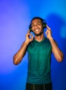Fit Man Wearing Headphones Enjoying Music Standing Over Blue Background Royalty Free Stock Photo