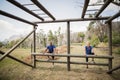 Fit man and woman climbing monkey bars during obstacle course Royalty Free Stock Photo