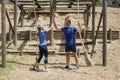 Fit man and woman giving high-five to each other during obstacle course Royalty Free Stock Photo