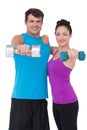 Fit man and woman lifting dumbbells Royalty Free Stock Photo