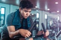 Fit man working out on exercise bike at the gym. Healthy and funny lifestyle concept Royalty Free Stock Photo