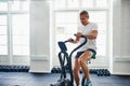 Fit mature man exercising on a health club stationary bike