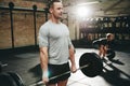 Fit man lifting weights during a gym workout session