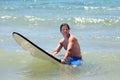 Fit middle aged man surfing on beach in summer Royalty Free Stock Photo