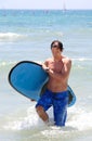 Fit middle aged man surfing on beach in summer Royalty Free Stock Photo