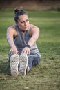 Fit middle aged woman stretching and breathing after a workout Royalty Free Stock Photo