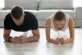 Toned young couple stand in forearm plank training together Royalty Free Stock Photo