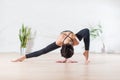 Fit modern dancer standing gracefully on tiptoe in wide side lunge facedown pose indoors. Royalty Free Stock Photo