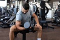 Fit and muscular indian man trains with dumbbells