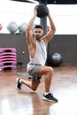 Fit and muscular man exercising with medicine ball at gym. Royalty Free Stock Photo