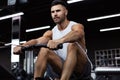 Fit and muscular man using rowing machine at gym Royalty Free Stock Photo