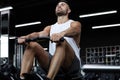 Fit and muscular man using rowing machine at gym Royalty Free Stock Photo