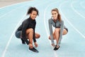 Fit is not a destination, its a way of life. Full length portrait of two attractive young athletes crouching together Royalty Free Stock Photo