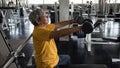 Fit old man dumbbell exercise in gym Royalty Free Stock Photo