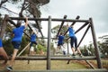 Fit people climbing monkey bars in bootcamp Royalty Free Stock Photo