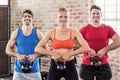 Fit people do some weightlifting together Royalty Free Stock Photo