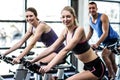 Fit people working out at spinning class Royalty Free Stock Photo