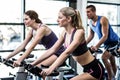 Fit people working out at spinning class Royalty Free Stock Photo