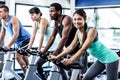 Fit people working out at spinning class Royalty Free Stock Photo