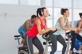 Fit people working out at spinning class Royalty Free Stock Photo