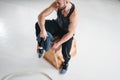 Fit perspiring man sitting on box in fitness hall