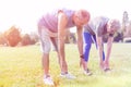 Fit senior couple doing toe touching exercise in park Royalty Free Stock Photo