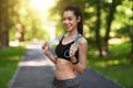 Fit smiling asian woman posing with skipping jump rope outdoors Royalty Free Stock Photo