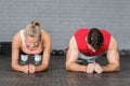 Fit smiling couple planking together in gym Royalty Free Stock Photo