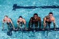 Fit smiling group pedaling on swimming bike Royalty Free Stock Photo