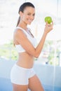 Fit smiling woman holding green apple Royalty Free Stock Photo