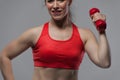 Fit smiling woman posing with red dumbbell Royalty Free Stock Photo