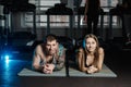 Fit sportive man and woman doing plank core exercise training back and press muscles concept gym sport sportsman fitness Royalty Free Stock Photo