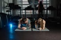 Fit sportive man and woman doing plank core exercise training back and press muscles concept gym sport sportsman fitness Royalty Free Stock Photo