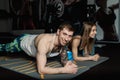 Fit sportive man and woman doing plank core exercise training back and press muscles concept gym sport sportsman fitness Royalty Free Stock Photo