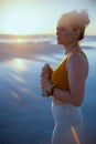 Fit sports woman in sport clothes at beach at sundown