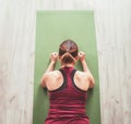 Fit sporty healthy woman on mat in low plank Chaturanga Dandasana yoga pose, doing breathing exercises, watching online yoga class Royalty Free Stock Photo