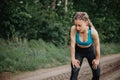 Fit sporty woman take breath at jogging workout