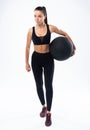 Fit and strong female athlete working out with a medicine ball to get better core strength and stability