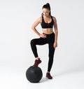 Fit and strong female athlete working out with a medicine ball to get better core strength and stability
