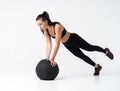 Fit and strong female athlete working out with a medicine ball to get better core strength and stability